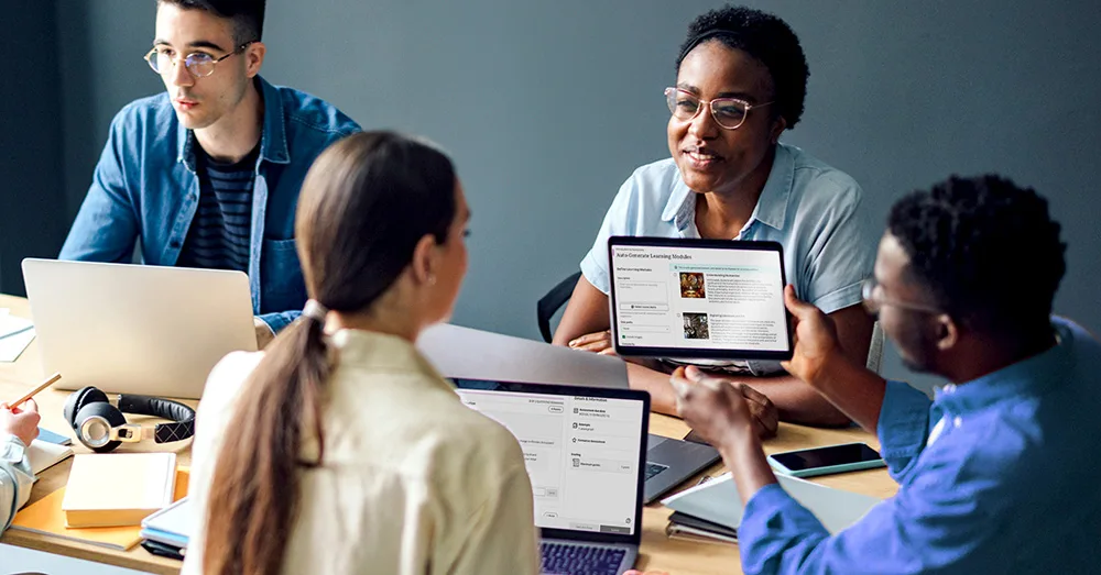 Group of students with laptops and a tablet displaying Blackboard Learning Modules