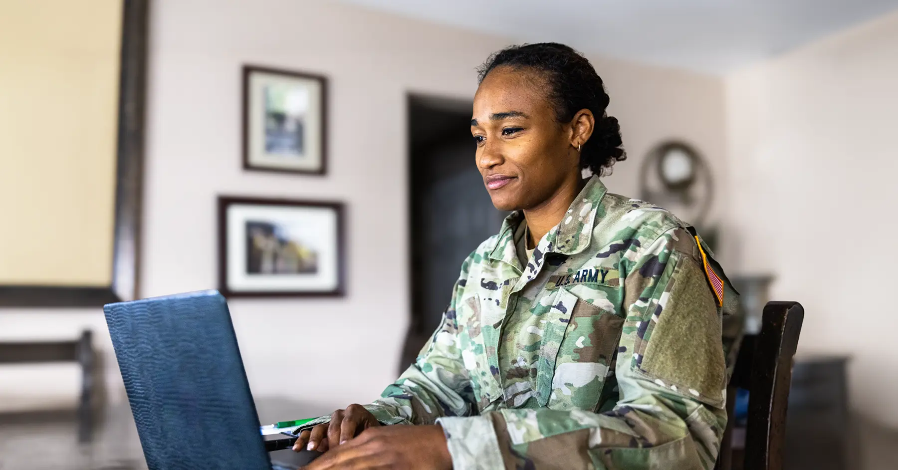 Photo of a soldier in Army fatigues using IL4 authorized Blackboard on a laptop