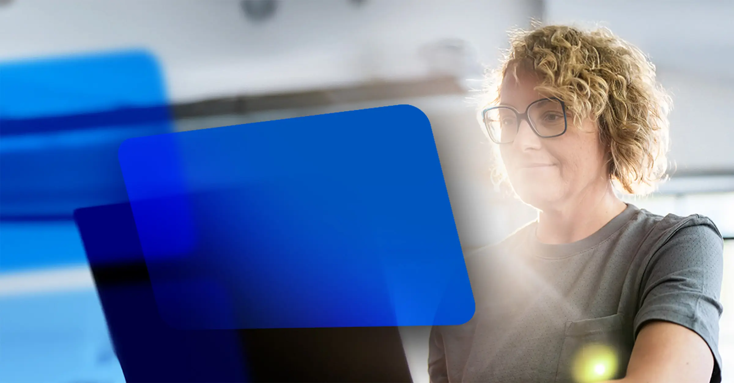 Photo of a woman at her computer using Video Studio in Blackboard