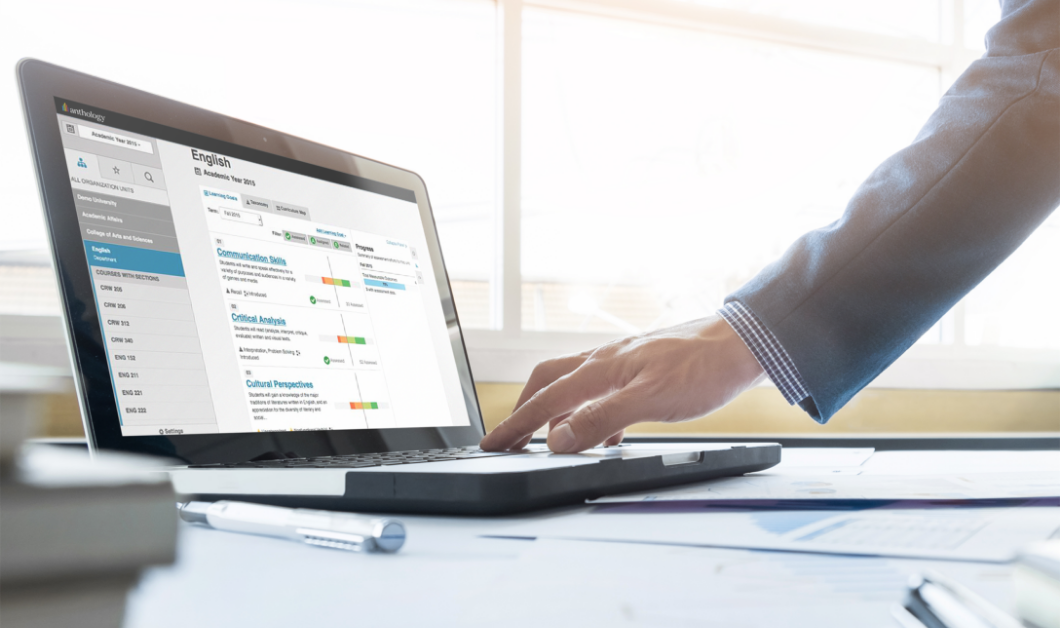 Person viewing dashboards in Blackboard Outcomes on a laptop