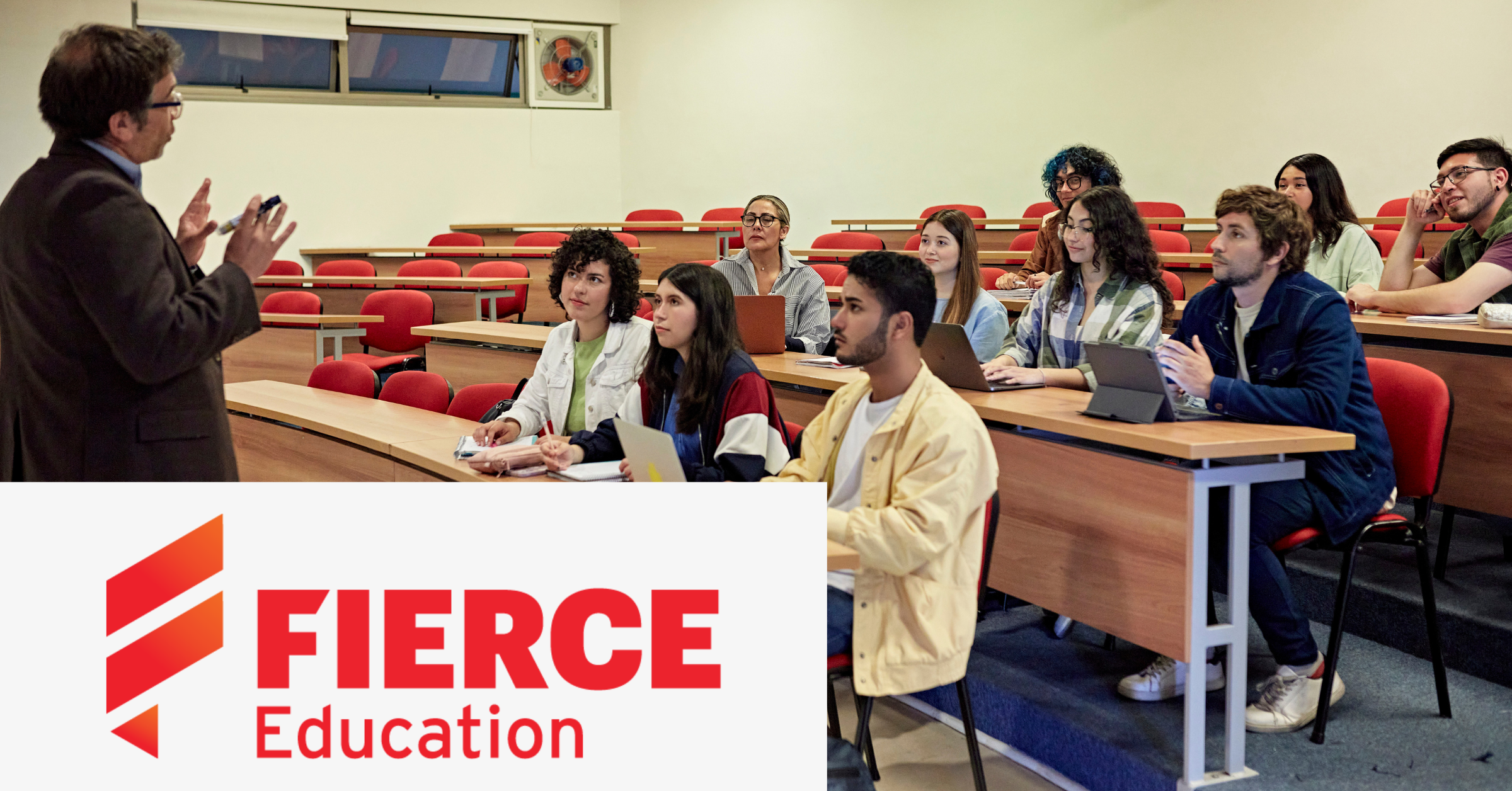 Image of a teacher talking to his students in a classroom. On the lower left corner of the graphic is placed the Fierce Education logo.
