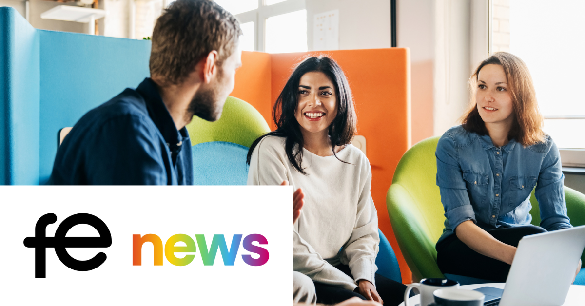 Photo of four people standing around talking