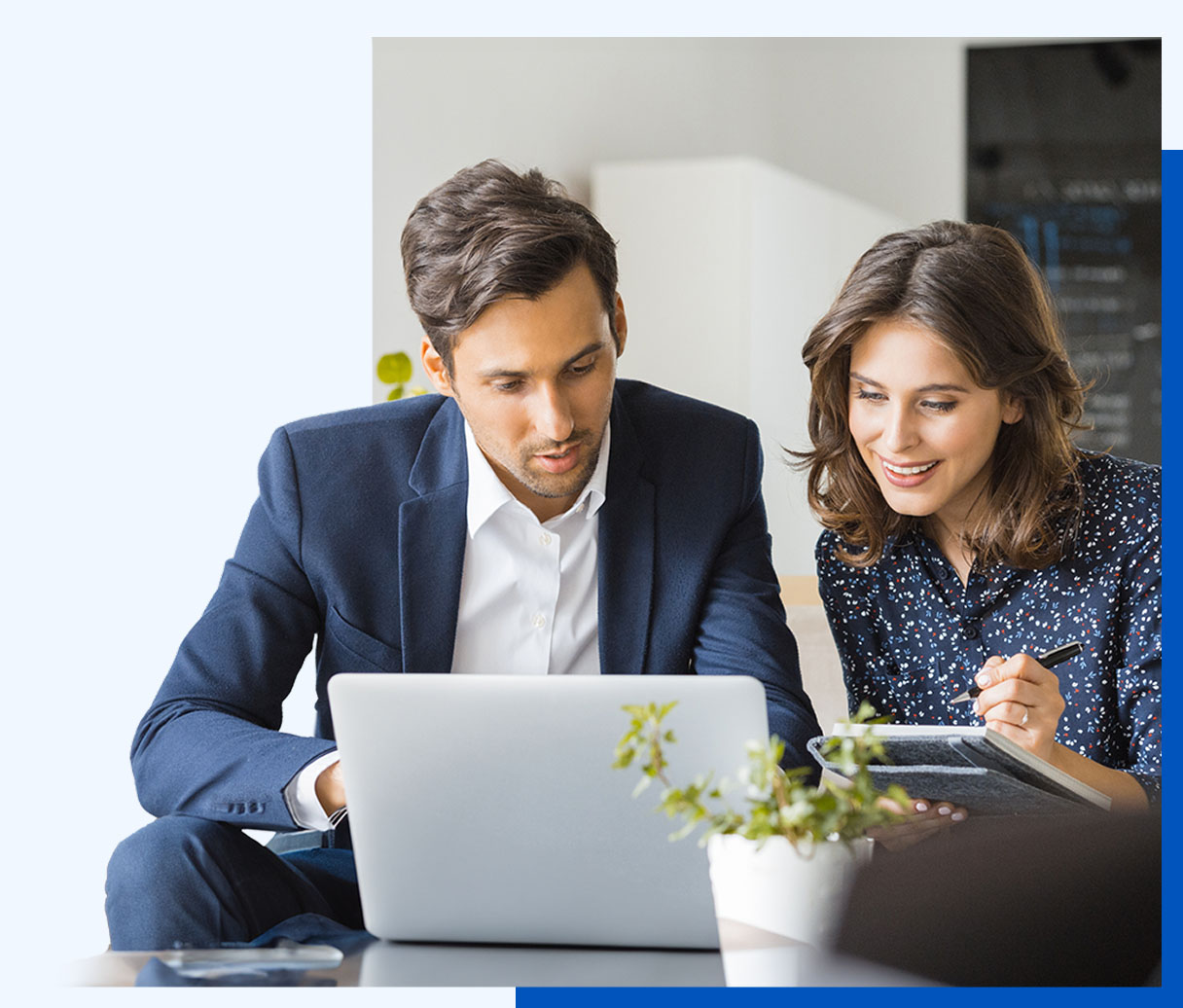 Photo of a man and a woman working together at a laptop